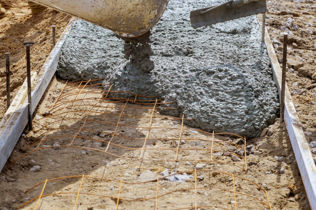 Cement mixer truck pouring cement during sidewalk
